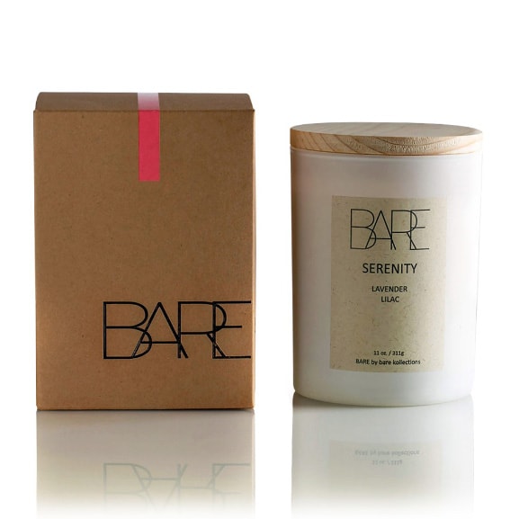 White background. Recycable brown box with Bare logo on the left side. Next to it, on the right side, Serenity scented candle in a closed white jar with beige label on it that says BARE, Lavender, Lilac.